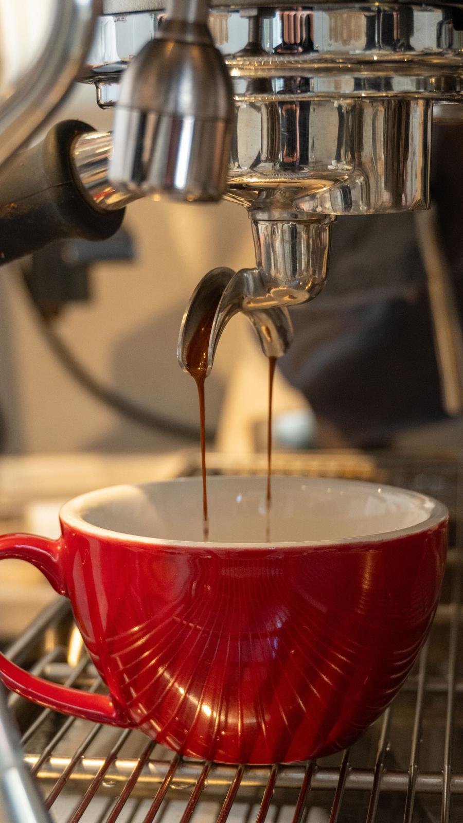 Espresso cayendo en taza roja